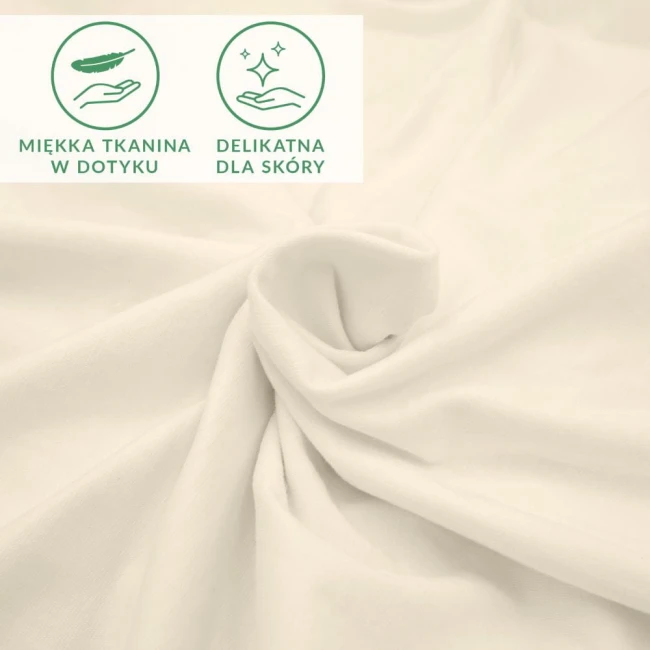 Prześcieradło jersey z elastanem o wymiarach 200x220 cm, w kolorze ekologicznym. Złożone tkaniny ukazujące gładką, miękką fakturę, idealne do użytku w sypialni. Widoczne ikony informujące o delikatności materiału dla skóry.