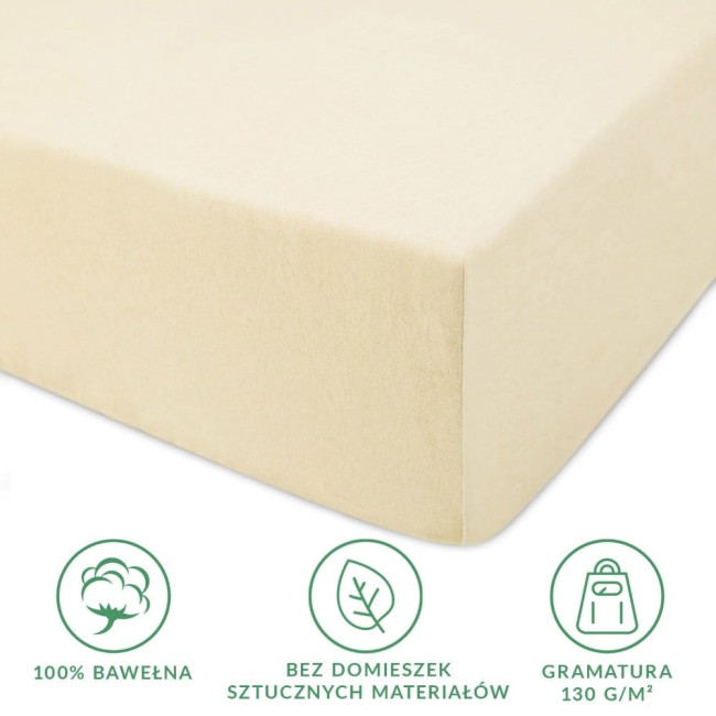 Prześcieradło jersey z gumką 90x200 w kolorze kremowym, wykonane w 100% z bawełny. Widok z boku, prezentujące elastyczny brzeg i gładką fakturę. Na dole napis „Bez domieszek sztucznych materiałów” oraz ikony przedstawiające skład i gramaturę 130 g/m².