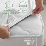 Prześcieradło jersey z gumką 120x200 w kolorze białym, leżące na materacu, z dobrze widocznym bokiem gumki. Oznaczenia na tle zachęcają do użycia, wskazując, że nie zsuwa się z materaca oraz pasuje do wysokości 20 cm.