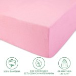 Prześcieradło jersey z gumką 90x200 w kolorze jasnym różu, wykonane w 100% z bawełny, o gramaturze 130 g/m². Złożone, ukazujące brzeg i fakturę materiału. Widoczne ikonki informacyjne o braku domieszek materiałów sztucznych.