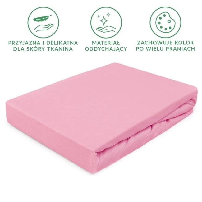 Prześcieradło jersey z gumką 140x200 w kolorze jasnego różu, leżące na białym tle. Materiał teksturowany, przyjazny dla skóry, z zaokrąglonymi krawędziami. Widoczne informacje o oddychającym materiale i utrzymywaniu koloru po praniach.