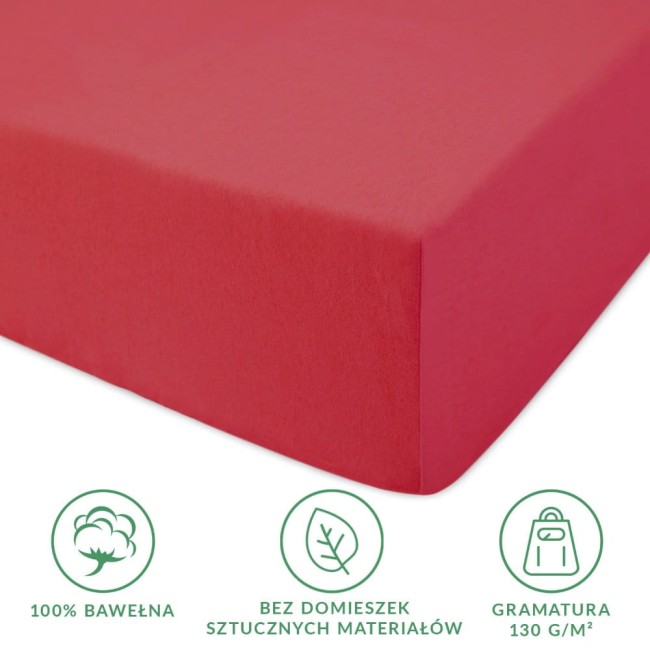 Prześcieradło jersey z gumką 40x90 w kolorze koralowym, wykonane z 100% bawełny. Produkt leży na gładkim tle, ukazując bok z dokładnym dopasowaniem do materaca. Widoczne informacje o braku domieszek sztucznych materiałów oraz gramaturze 130 g/m².