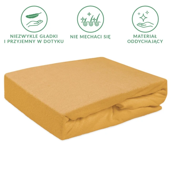 Prześcieradło frotte z gumką w kolorze musztardowym, rozmiar 90x200 cm, leży na białym tle. Produkt ma gładką, teksturowaną powierzchnię, bez widocznych napisów czy logo. Złożone z jednej strony, ukazuje gumkę, co zapewnia dopasowanie do materaca.