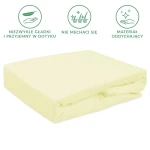 Prześcieradło frotte z gumką 180x200, kremowe, leżące na powierzchni. Materiał teksturowany, miękki w dotyku. Widoczna gumka zapewniająca stabilność. Tło jednolite, skupione na produkcie.