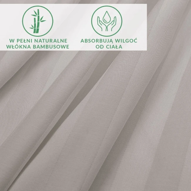 Prześcieradło bambusowe, szare, o fakturze satynowej, z wyraźnymi pasami. Widoczne napisy informujące o naturalnych włóknach bambusowych oraz ich właściwościach. Produkt ułożony w złożony sposób, pokazujący detale materiału.