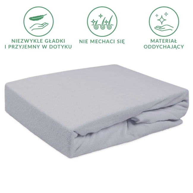 Prześcieradło frotte z gumką w kolorze popielatym, o wymiarach 200x220 cm, leżące na boku. Materiał jest miękki, gładki w dotyku, odporny na mechacenie. Idealne do użytku na materacu, zapewniające komfort i estetykę.
