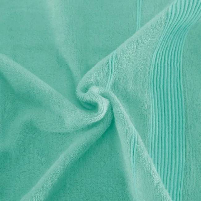 Ręcznik bambusowy 70x140 w kolorze turkusowym, z widoczną, miękką fakturą i delikatnym wzorem na brzegach. Produkt leży płasko, w zbliżeniu na szczegóły tkaniny, akcentując jej chłodny kolor i teksturę.