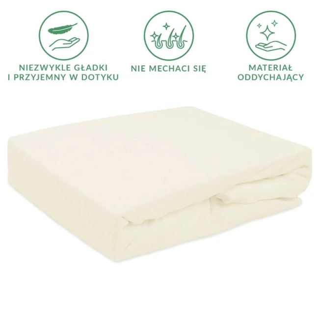 Prześcieradło frotte z gumką w kolorze ecru, o wymiarach 60x120 cm, leży na białym tle. Produkt jest gładki, z zabezpieczeniem gumkowym, bez widocznych tekstów lub wzorów. Idealne do łóżeczka dziecięcego, zapewnia komfort oraz stabilność.