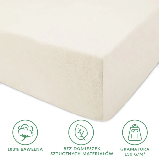 Prześcieradło jersey z gumką 80x180 w kolorze ecru, leżące na płaskiej powierzchni. Wykonane w 100% z bawełny, z gramaturą 130 g/m², bez sztucznych dodatków. Widoczne elastyczne wykończenie brzegów przystosowane do materaca.