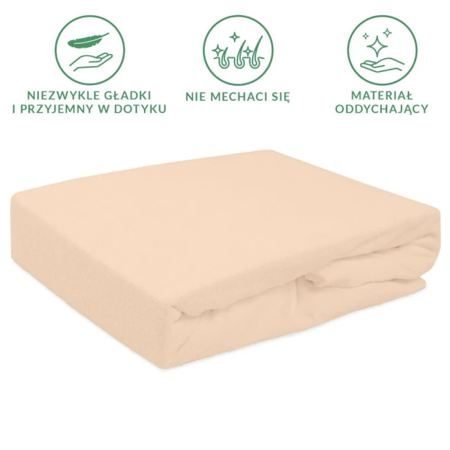 Prześcieradło frotte z gumką 140x200 w kolorze różu perłowego, leżące na białym tle. Produkt o gładkiej fakturze, zestawione w elegancki sposób, z widoczną gumką, zapewniającą dopasowanie do materaca.