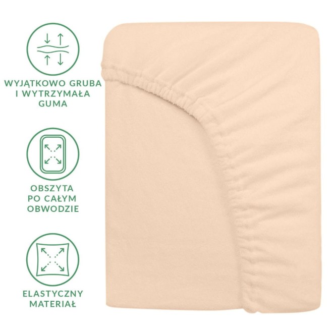 Prześcieradło frotte z gumką 200x220 w kolorze różu perłowego, leżące na białym tle. Zbliżenie na krawędzie z elastyczną guma, obszytą po całym obwodzie, ukazująca fakturę materiału.