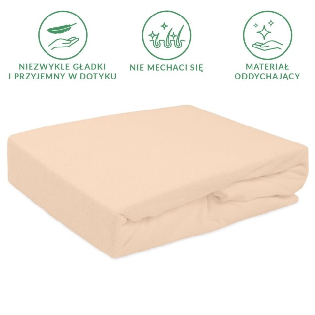 Prześcieradło frotte z gumką w kolorze róż perłowy, leżące na płasko. Wykonane z miękkiego materiału, z widoczną gumką zapewniającą łatwe dopasowanie. Otoczenie na jednolitym tle, bez dodatkowych detali.