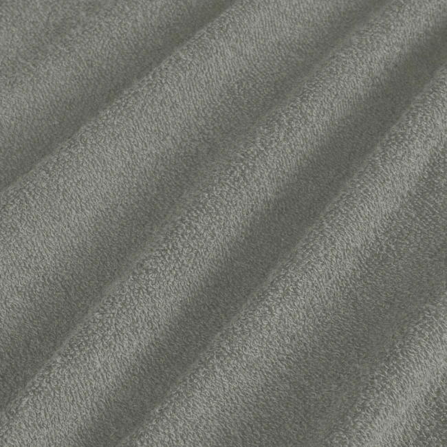 Poszewka frotte 40x40 w kolorze szarym, wykonana z miękkiego materiału o teksturowanej powierzchni. Produkt leży w złożeniu, co ukazuje jego elastyczność oraz sposób splotu. Brak widocznych napisów lub logo. Tło neutralne, nieodciągające uwagi.