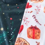 Ścierka kuchenna Christmas w komplecie 2 sztuk, o wymiarach 38x60 cm. Połowa w zielonym kolorze z dekoracjami gwiazdek i gałązek, druga w bieli z rysunkami prezentów i ciasteczek. Ułożone poziomo, ukazujące oba wzory obok siebie.