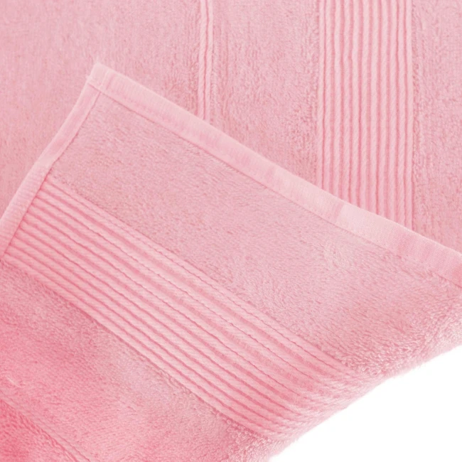 Ręcznik bambusowy o wymiarach 50x90 cm w kolorze różowym. Materiał miękki, z delikatnym wzorem wzdłużnym, leży płasko, pokazując teksturę tkaniny i podwójne obszycie.