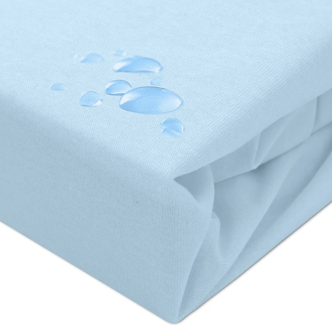 Ochronne prześcieradło z gumką 140x200 w kolorze błękitnym, leżące na gładkiej powierzchni. Materiał ma subtelną fakturę i jest częściowo zwinięty. Widoczne krople wody na tkaninie podkreślają właściwości wodoodporne.
