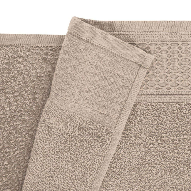 Komplet ręczników z bawełny w kolorze kości słoniowej, złożony, widoczny detal struktury tkaniny oraz dekoracyjny brzeg. Wzór na jednym z ręczników w formie rombów. Ręczniki miękkie, o matowej fakturze, leżą obok siebie.