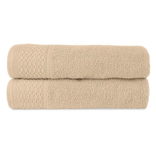 Komplet ręczników z bawełny Solano w kolorze jasnobeżowym, złożony z dwóch sztuk. Ręczniki mają teksturę pętelkową i dekoracyjny wzór w postaci siatki na brzegach. Produkt leży na białym tle, ukazując detale materiału i wykończenia.