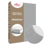 Prześcieradło jersey z gumką w kolorze popiel. Opakowanie prezentujące rozmiar 140x200 cm, z wyraźnym napisem „PREMIUM”. W dolnej części widoczny detal gumki oraz zaokrąglony brzeg prześcieradła, które pasuje na materac o wysokości do 25 cm.