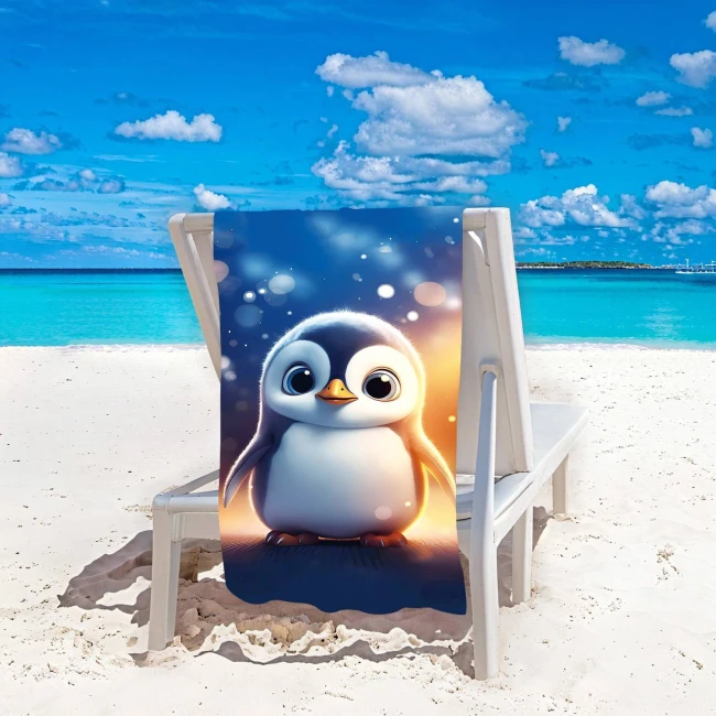 Ręcznik plażowy 100x180 cm z motywem pingwinka, wykonany z szybkoschnącej mikrofibry. Ułożony na leżaku na plaży. Kolory: niebieski z jasnym tłem. Wzór przedstawia uroczy pingwin z dużymi oczami. Idealny na wakacje nad morzem.