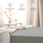 Prześcieradło bawełniane bez gumki w kolorze jasno szarym o wymiarach 200x220 cm, umieszczone na łóżku, lekko marszczone. Widoczna tkanina o gładkiej fakturze, otoczone białą pościelą. Na tle jasnego, naturalnego wnętrza.