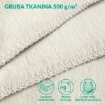Kremowy koc bawełniany 150x200 cm z frędzlami, wykonany z grubej tkaniny 500 g/m². Zbliżenie na teksturę i wykończenie brzegów, które podkreślają solidność materiału. Idealny do użytku w domu lub na tarasie.