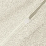 Poszewka frotte 40x80 w kolorze ecru, z widocznym zamkiem błyskawicznym. Materiał o delikatnej, teksturowanej powierzchni, idealny do dekoracji poduszek. Zbliżenie na fakturę i zamek, ukazujące szczegóły produktu.