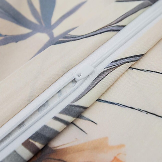 Zbliżenie na zamek błyskawiczny pościeli satynowej w kolorze kremowym z dekoracyjnym wzorem polnych czerwonych kwiatów. Widoczne detale tkaniny oraz mechanizm zamknięcia, podkreślające funkcjonalność i wykończenie produktu.